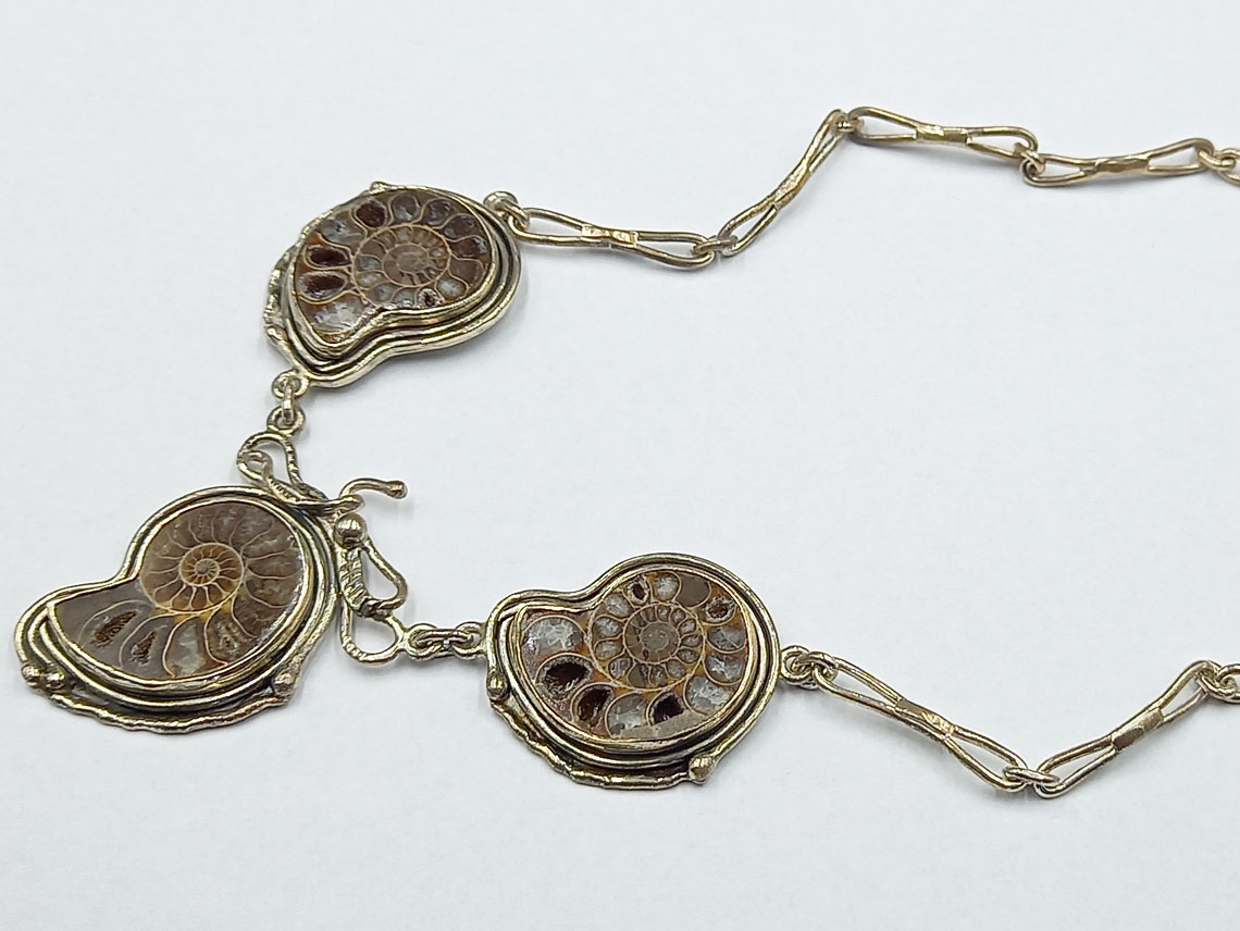 silver necklace with fossil