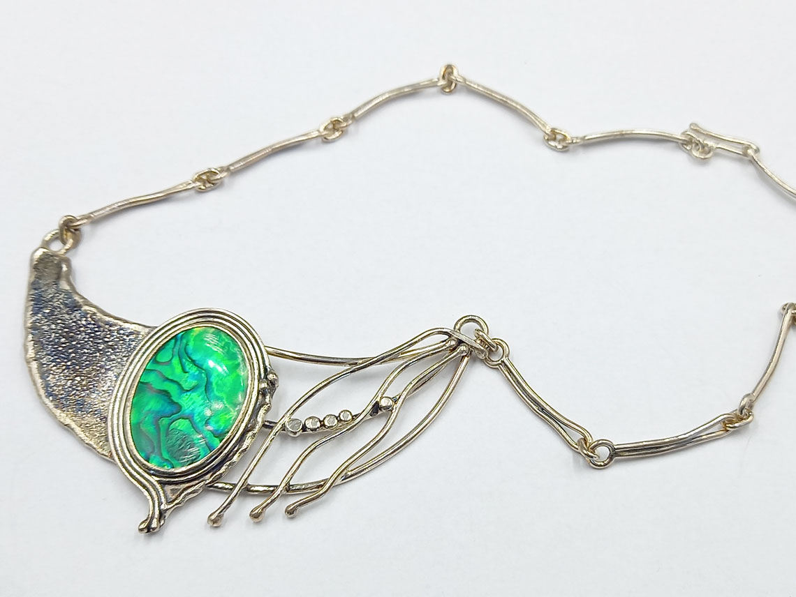 silver necklace with an avanon